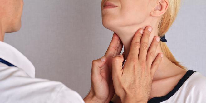 Untersucher tastet die Halslymphknoten einer Patientin