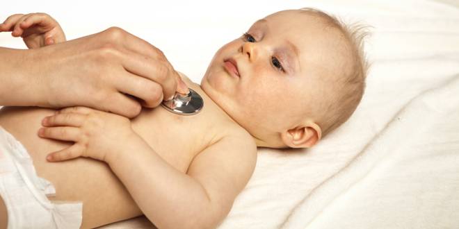 Baby liegt, Herz und Lungen werden durch ein Stethoskop abgehört.